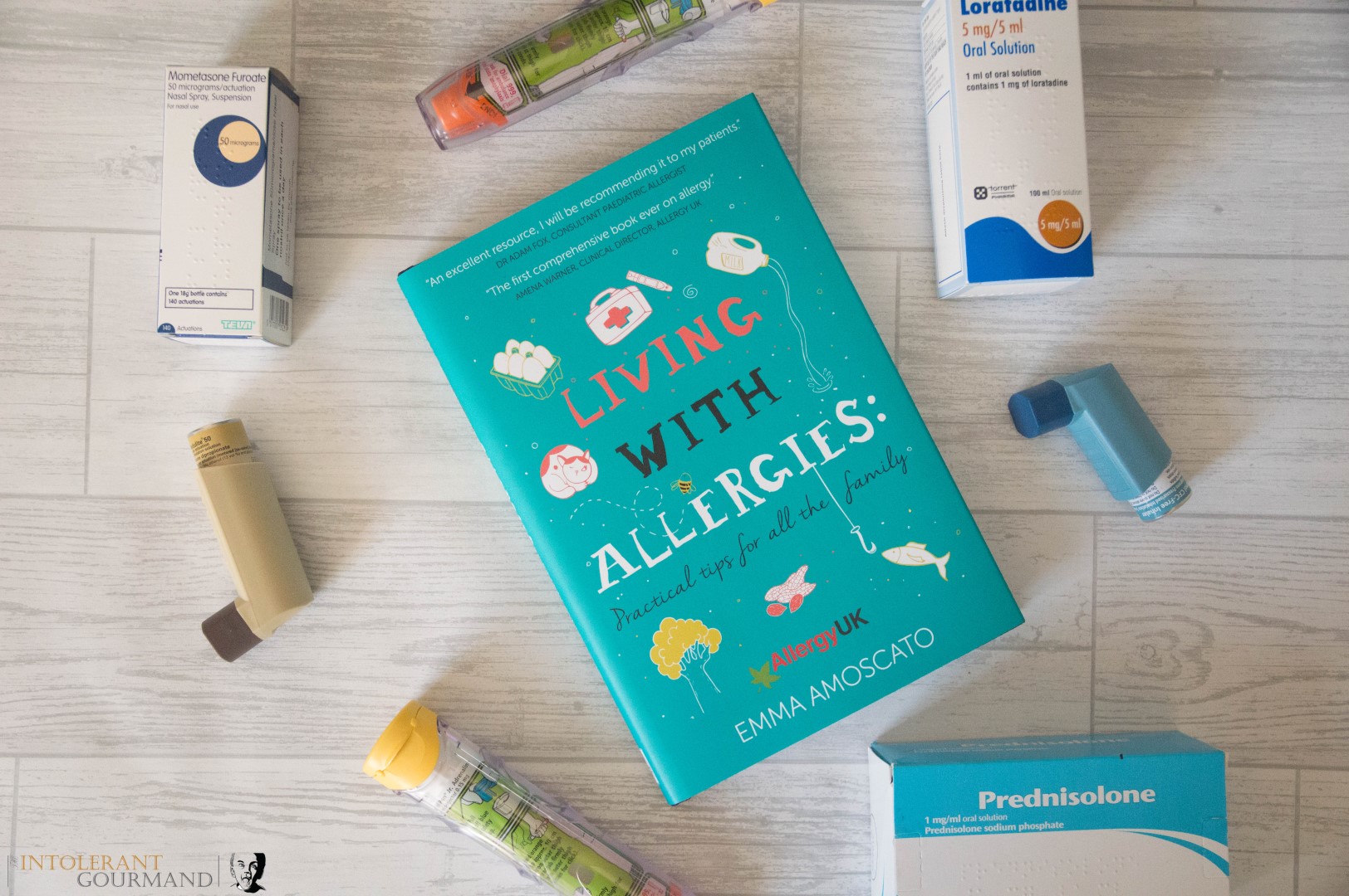 Living with allergies a guide to living and thriving with allergies - everything you need to know in the early days of diagnosis of allergies. Book surrounded by inhaler, epi pens, antihistamines and steroids. www.intolerantgourmand.com